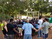 Team praying over children from Lac'ajue